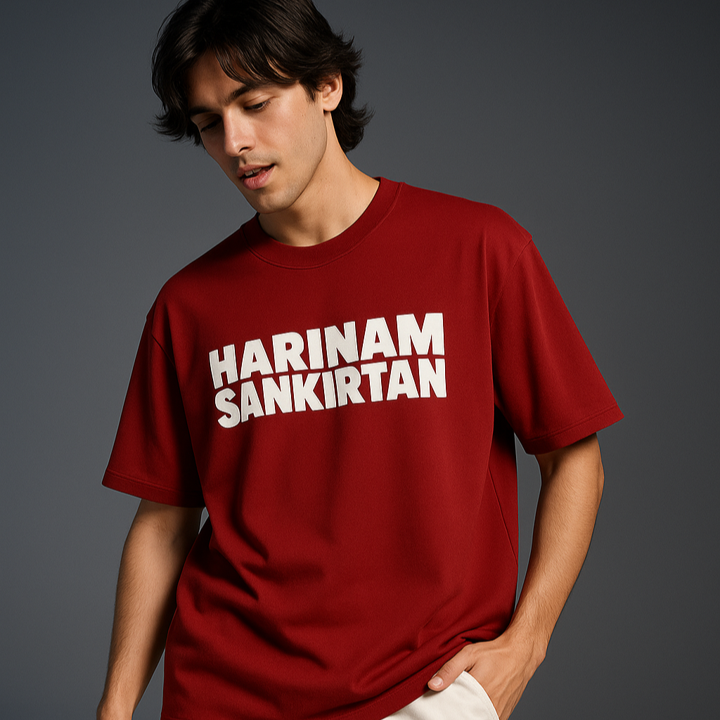 Person wearing a red t-shirt with 'HARINAM SANKIRTAN' text on a gray background