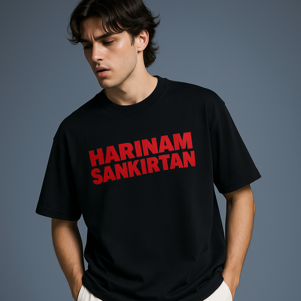 Person wearing a black t-shirt with red text against a gray background