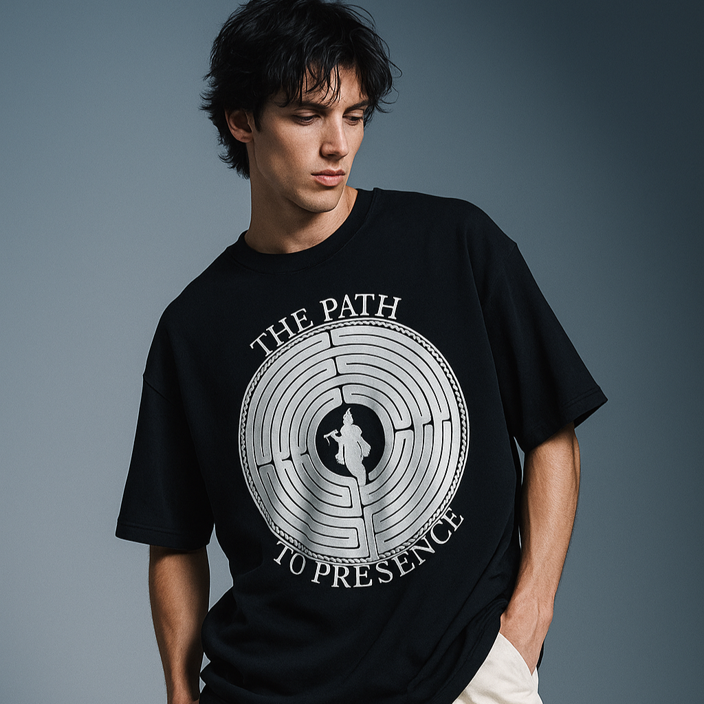 Person wearing a black t-shirt with a graphic design on a gray background