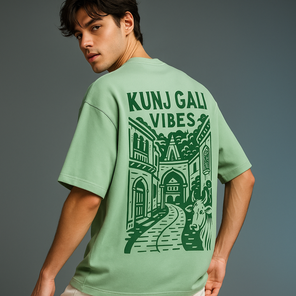 Person wearing a green t-shirt with 'Kunj Gali Vibes' design on the back against a gray background
