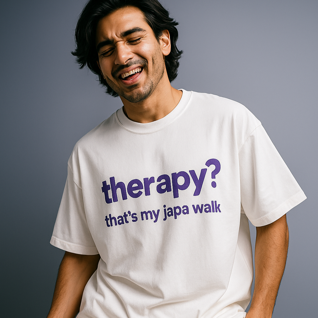 Person wearing a white t-shirt with a humorous text design on a gray background