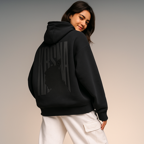 Person wearing a black hoodie with a brand logo on the back against a plain background