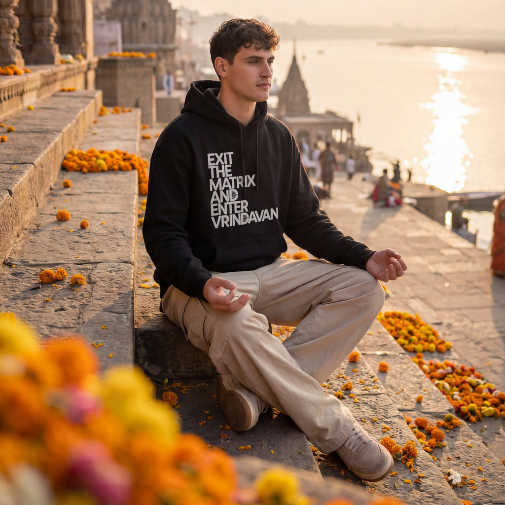 Person sitting on steps with a scenic background and text on hoodie