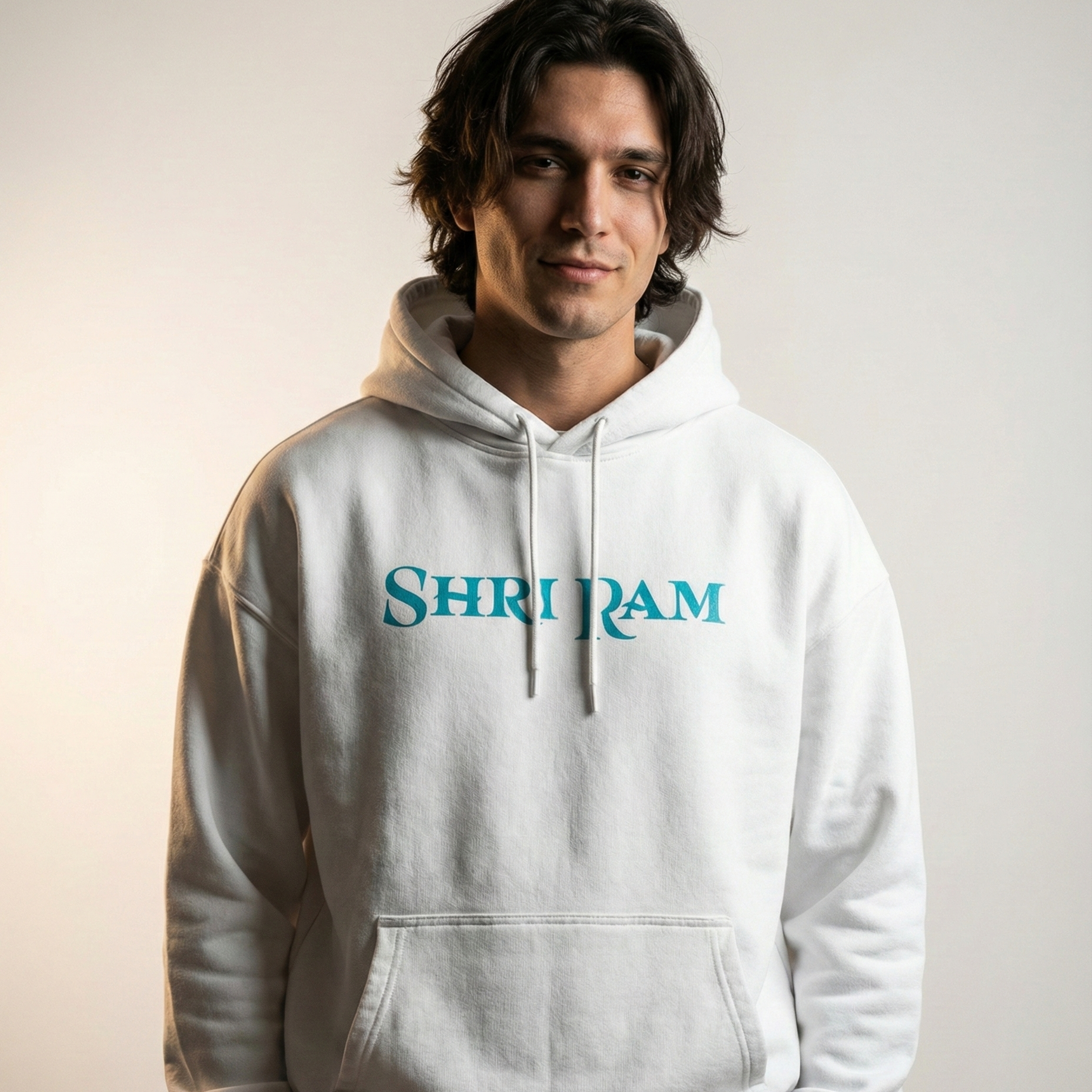 Person wearing a white hoodie with 'Shri Ram' printed on it against a neutral background