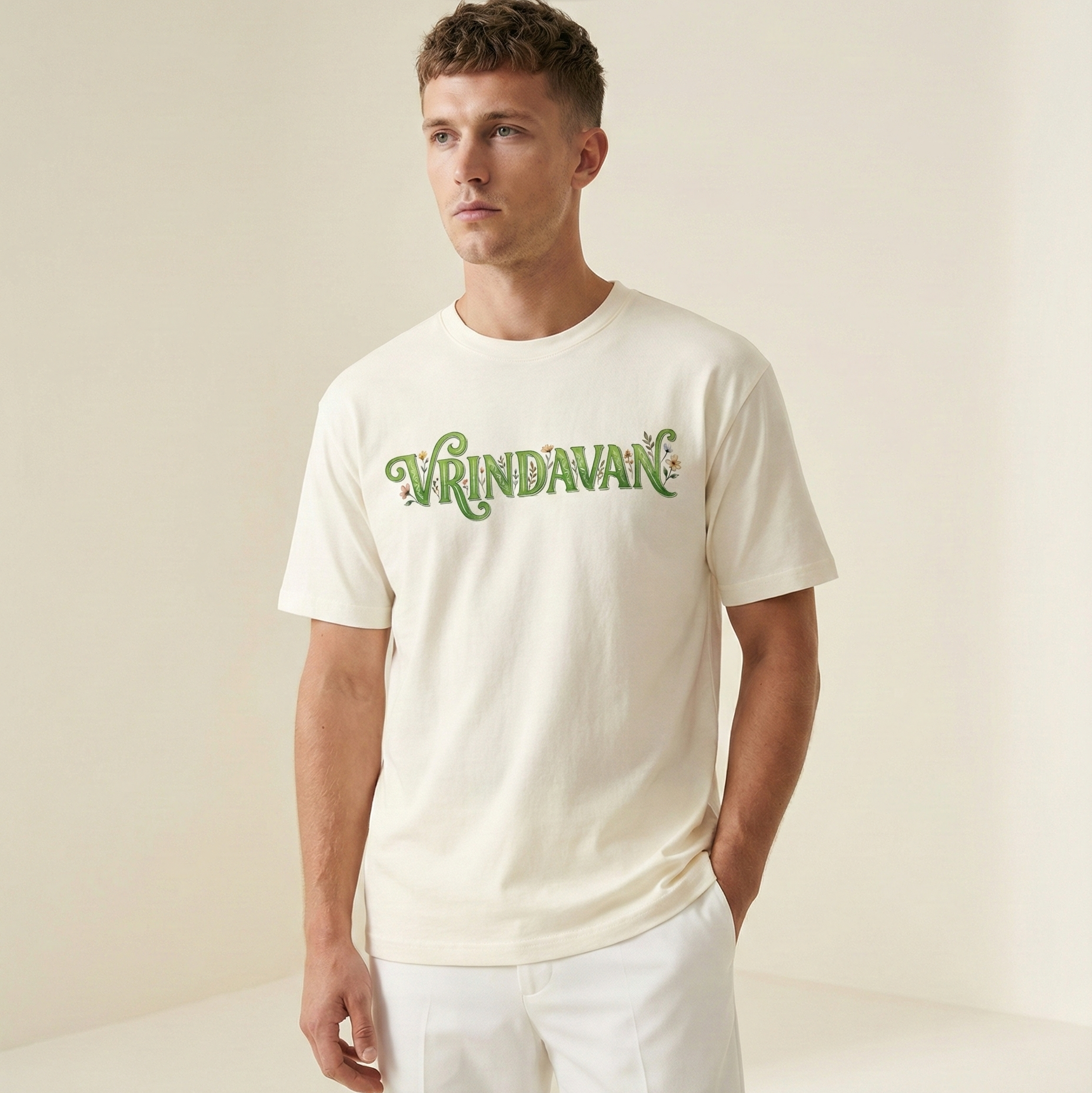 Man wearing a white t-shirt with green text against a plain background