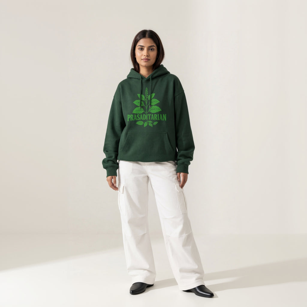 Person wearing a green hoodie with text, standing against a white background